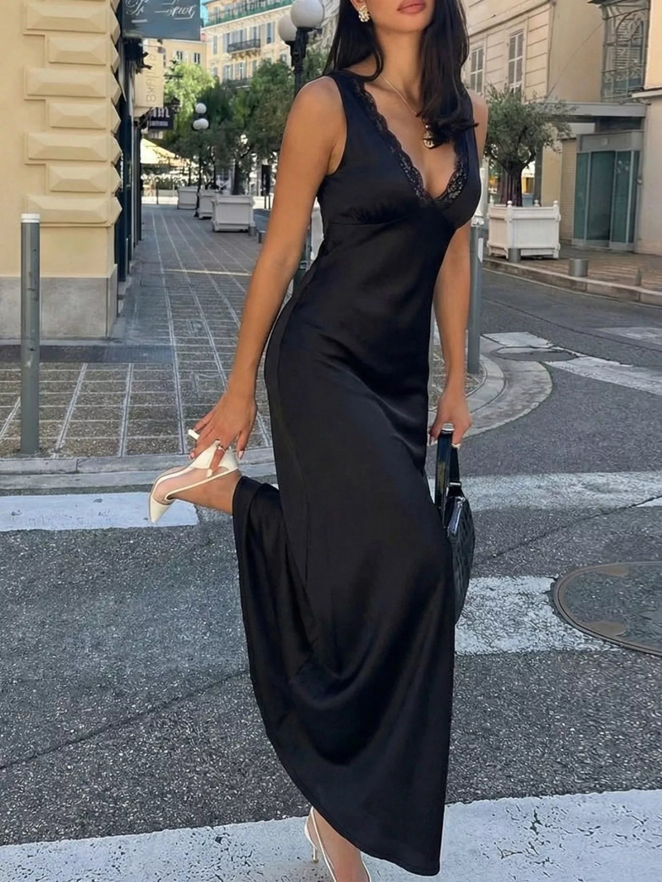 Black lace V-neck sleeveless maxi dress with a fitted waist and long skirt.
