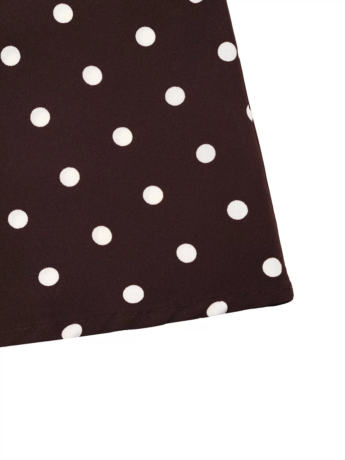 Coffee brown polka dot fabric close-up on skirt panel
