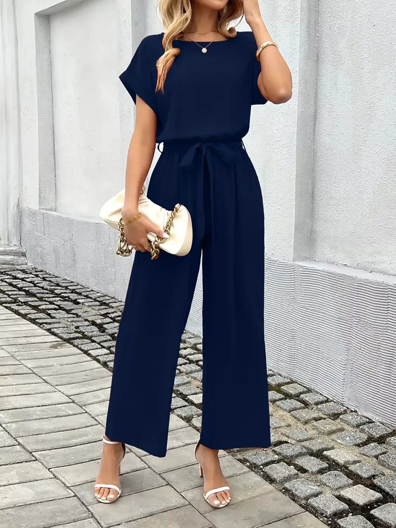 Dark blue tie-waist wide-leg jumpsuit with gathered waist tie and wide legs