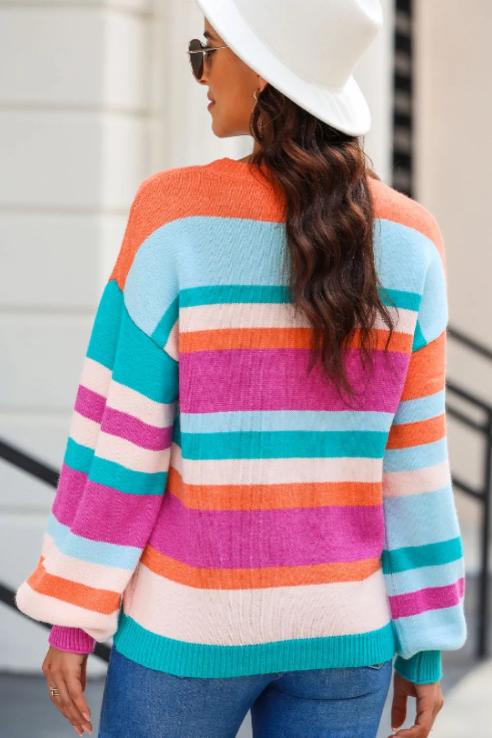 Striped sweater with multicolor horizontal bands, round neckline, and drop-shoulder sleeves.