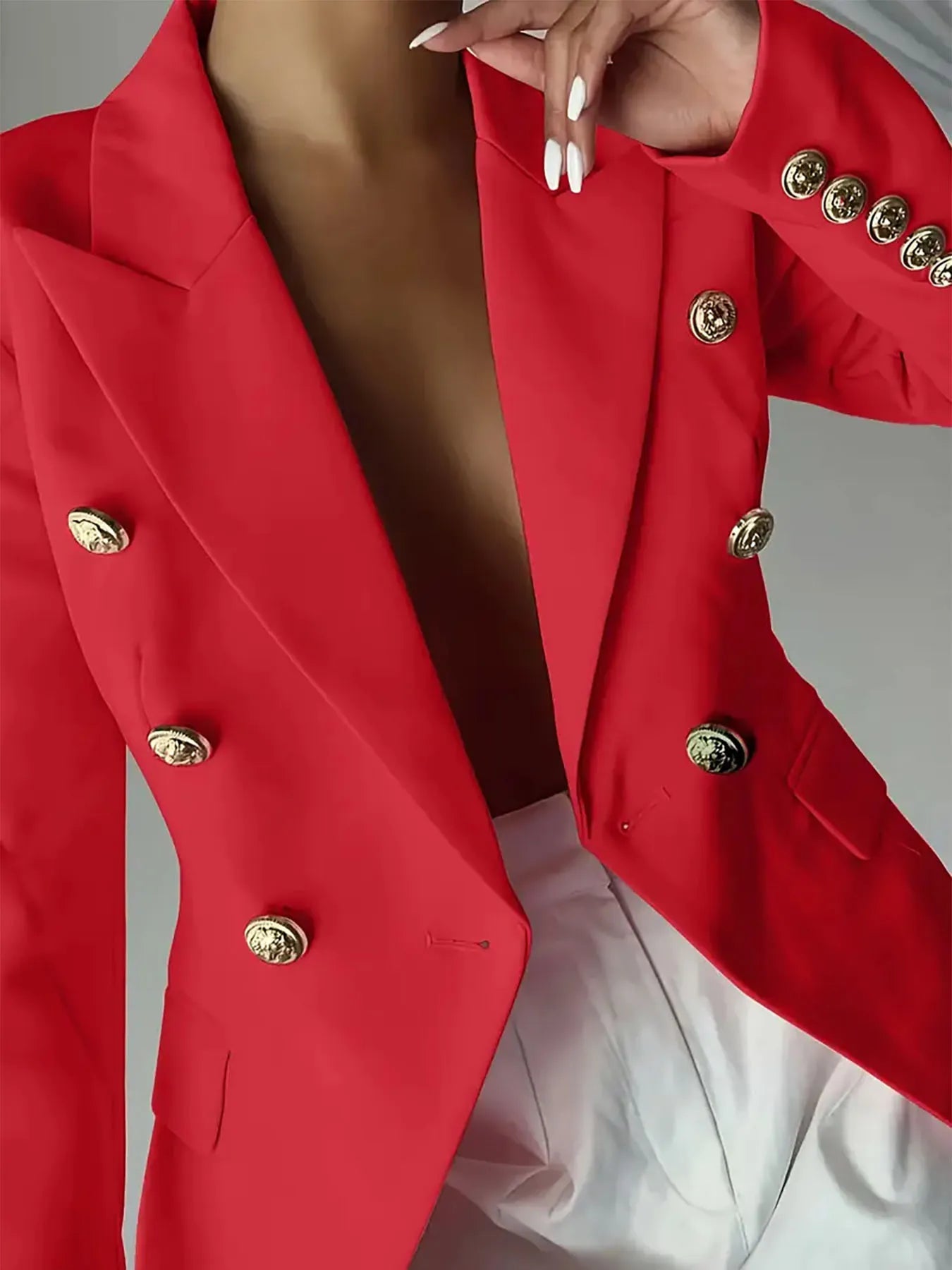 Red blazer with notch lapel and gold decorative buttons on front placket