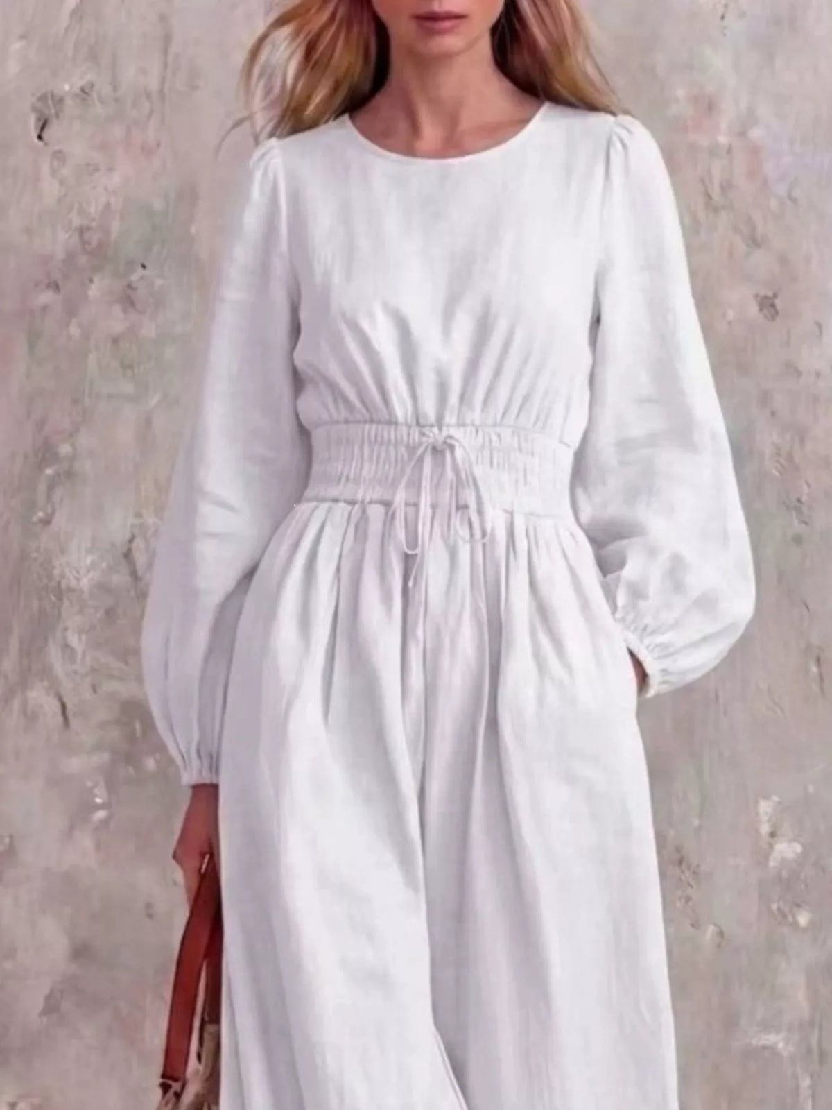 White smocked-waist long-sleeve jumpsuit with gathered bodice and wide legs