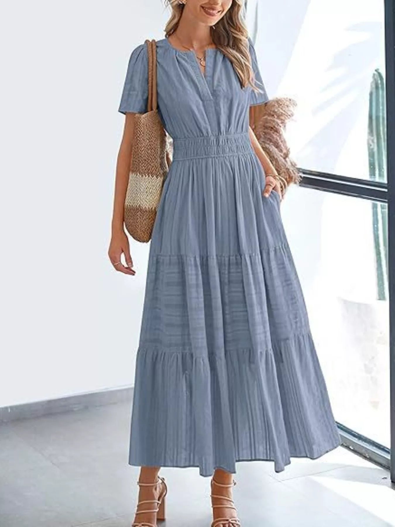 Tiered midi dress in steel blue, short sleeves, V-neck, smocked waist, tiered midi length.