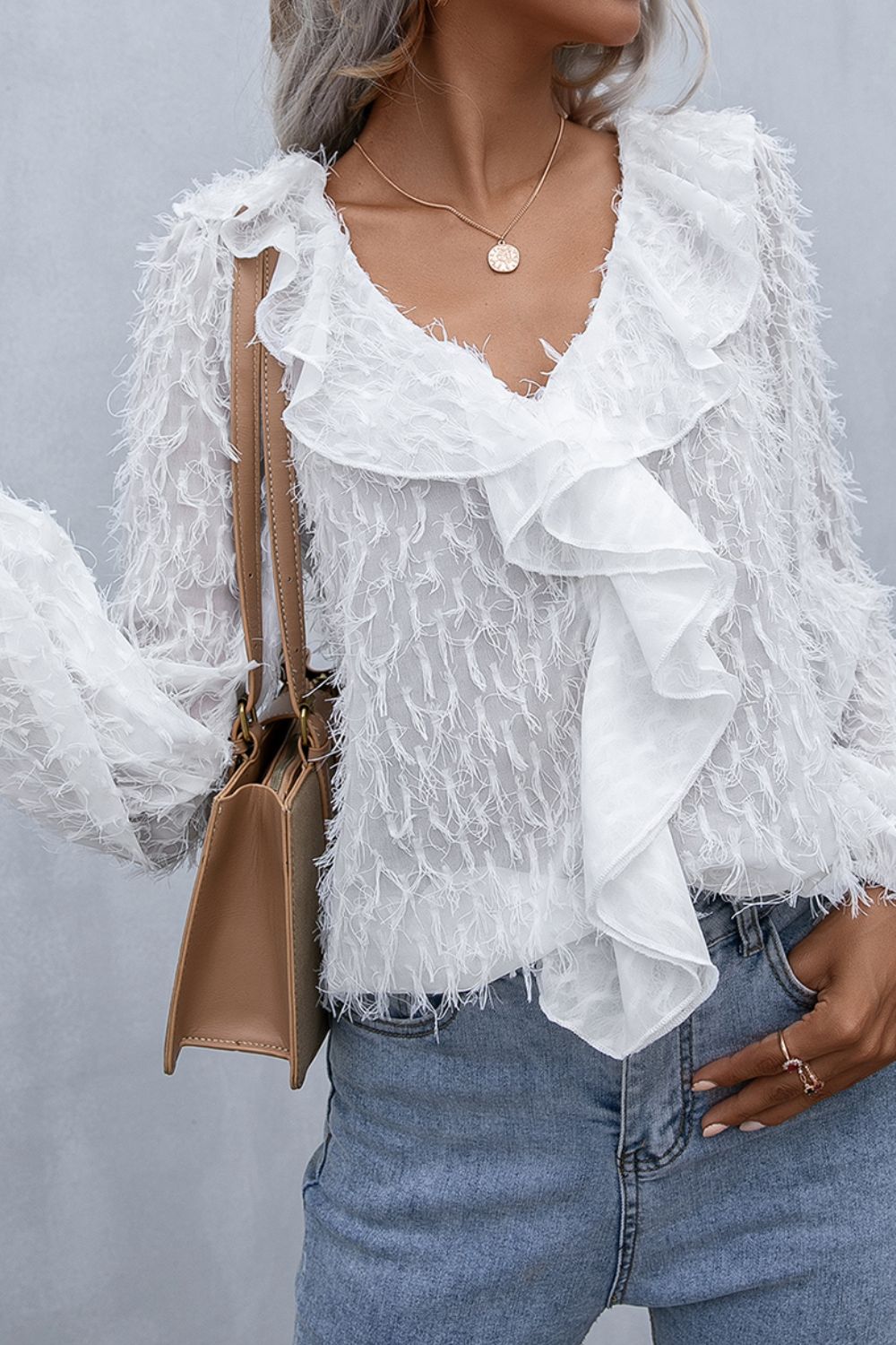 White ruffle-front blouse with balloon sleeves and layered neckline, side view