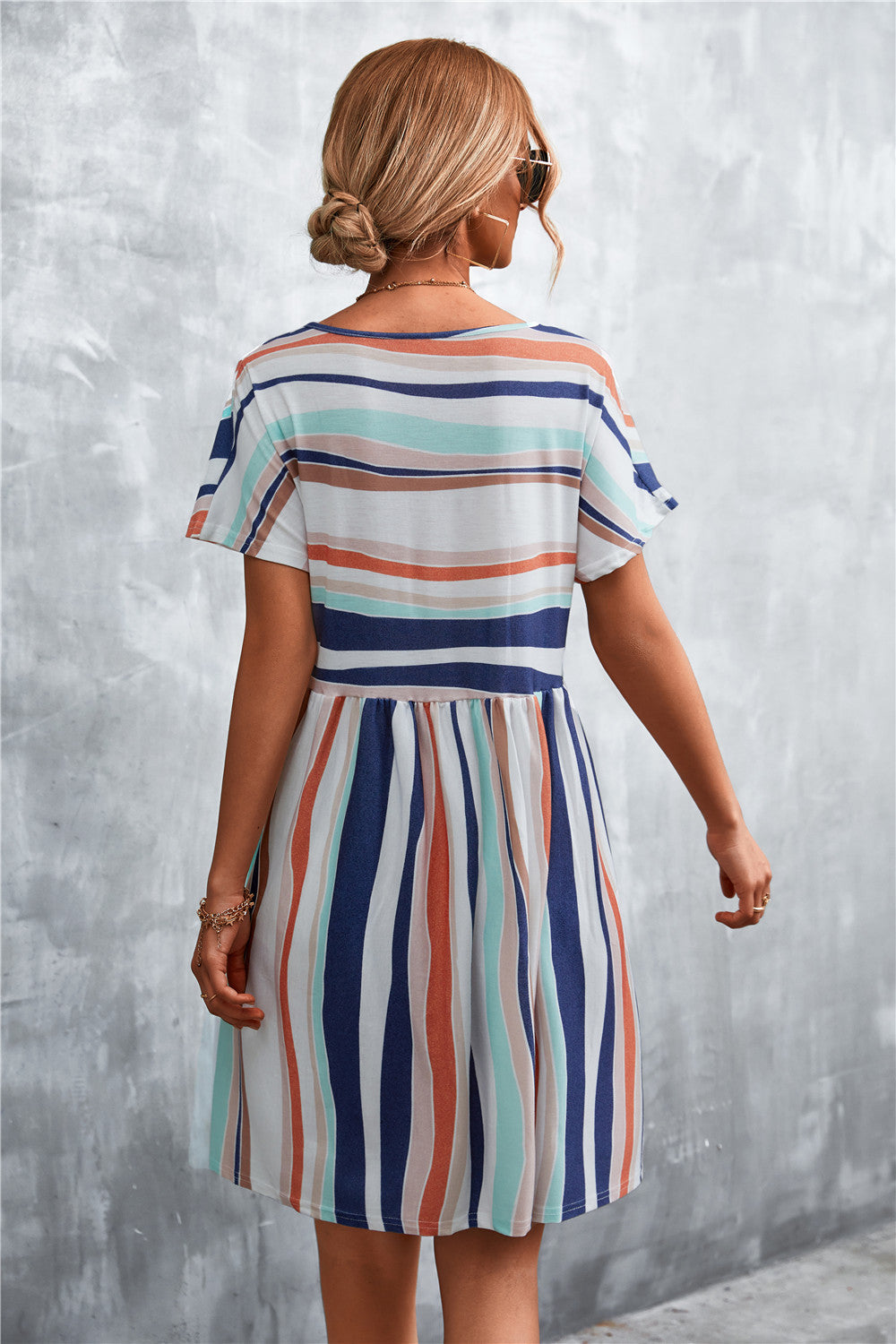 Back view striped round-neck dress with short sleeves and gathered waist, vertical multi-color stripes
