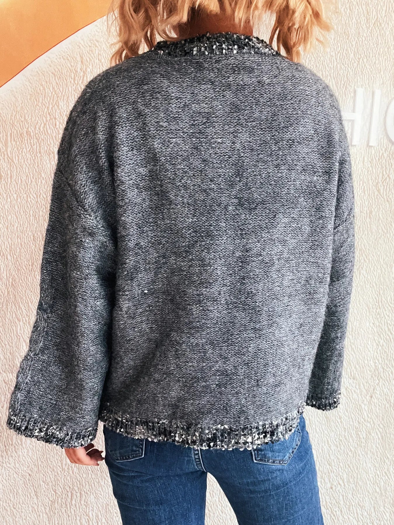 Dark gray back view of round-neck sweater with contrast-trim sleeves and hem.