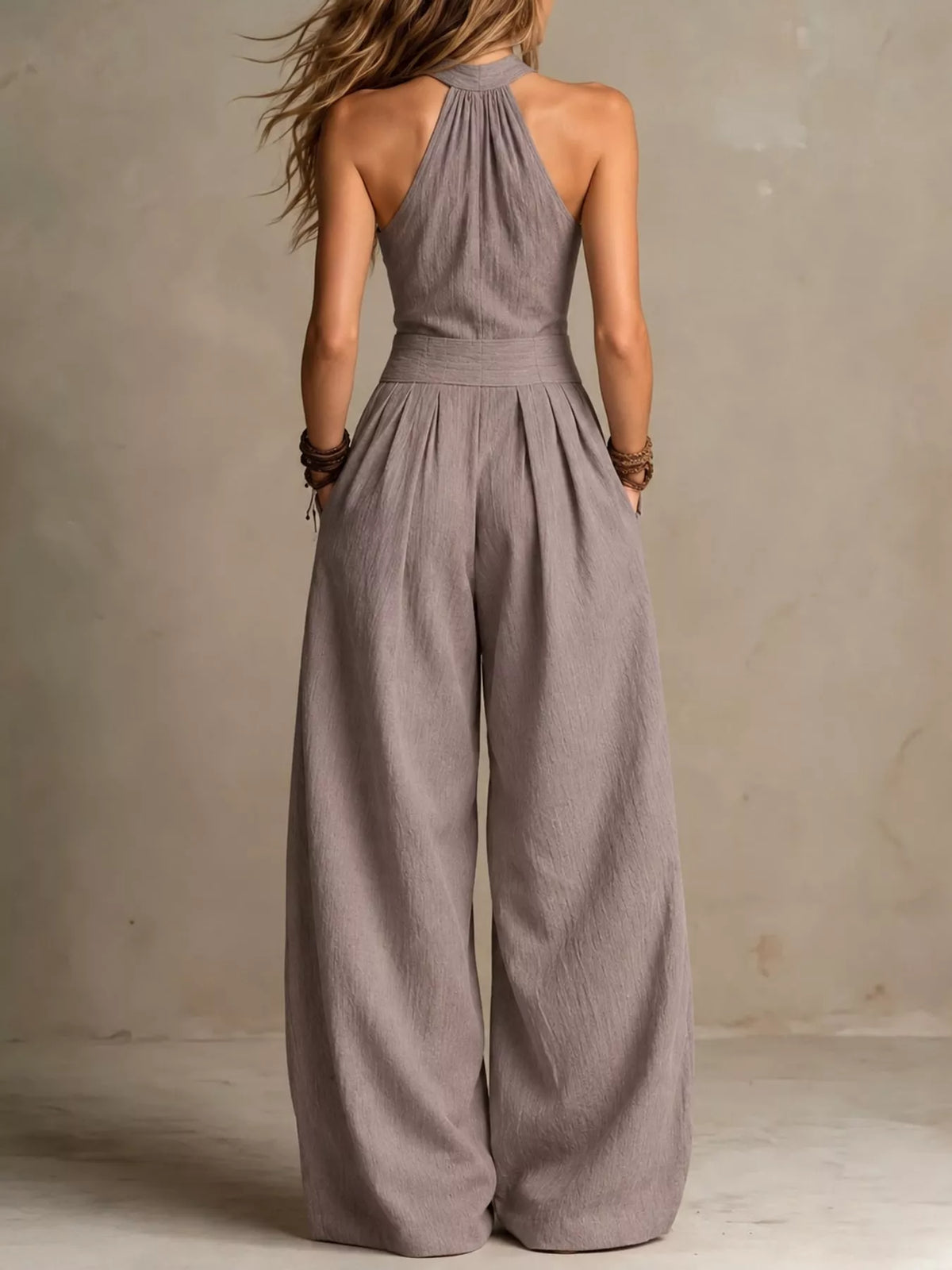 Light gray halter linen jumpsuit back view with keyhole neckline and wide-leg legs