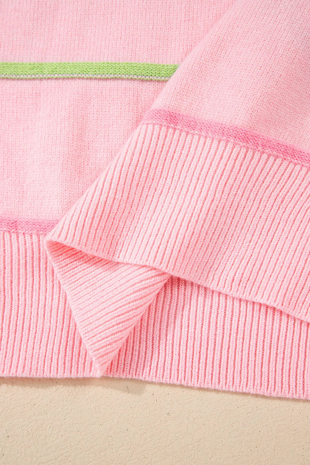 Blush pink ribbed knit cuffs and hem with pastel green/blue stripe trim details
