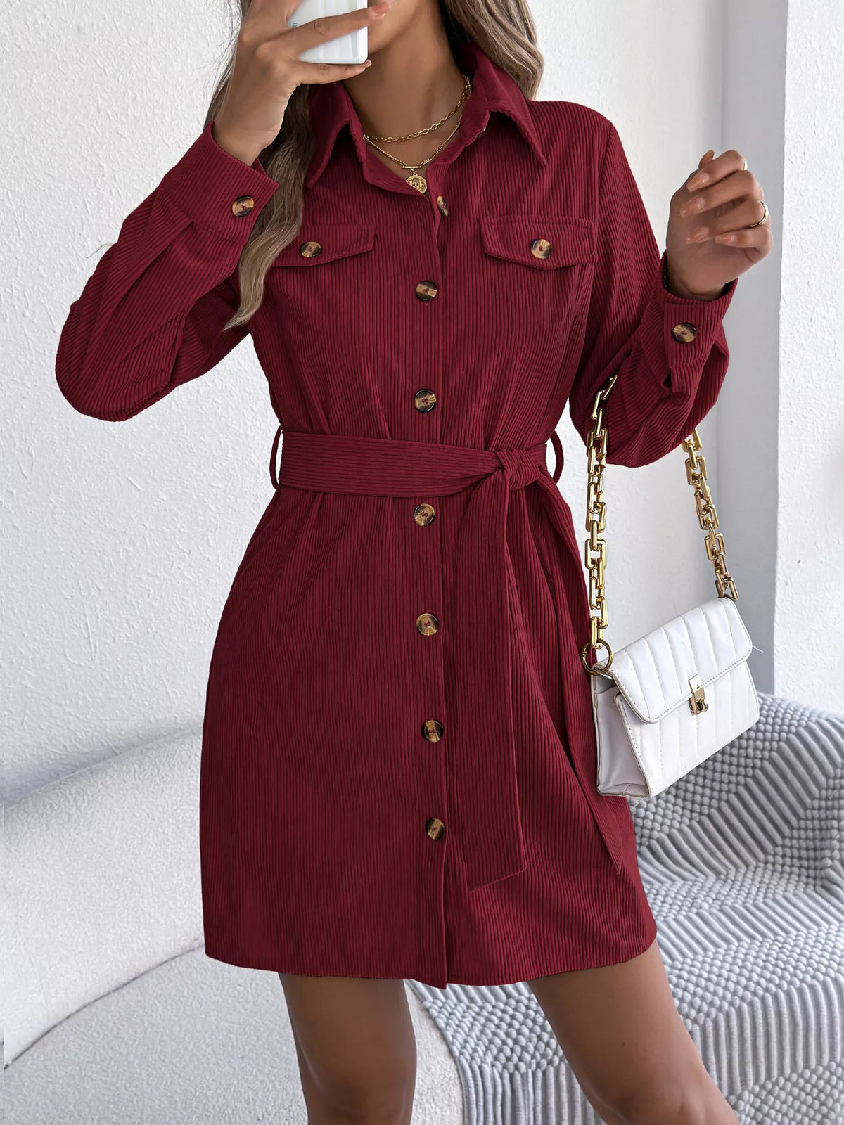 Burgundy corduroy shirt dress with chest pockets, button front, and waist tie belt