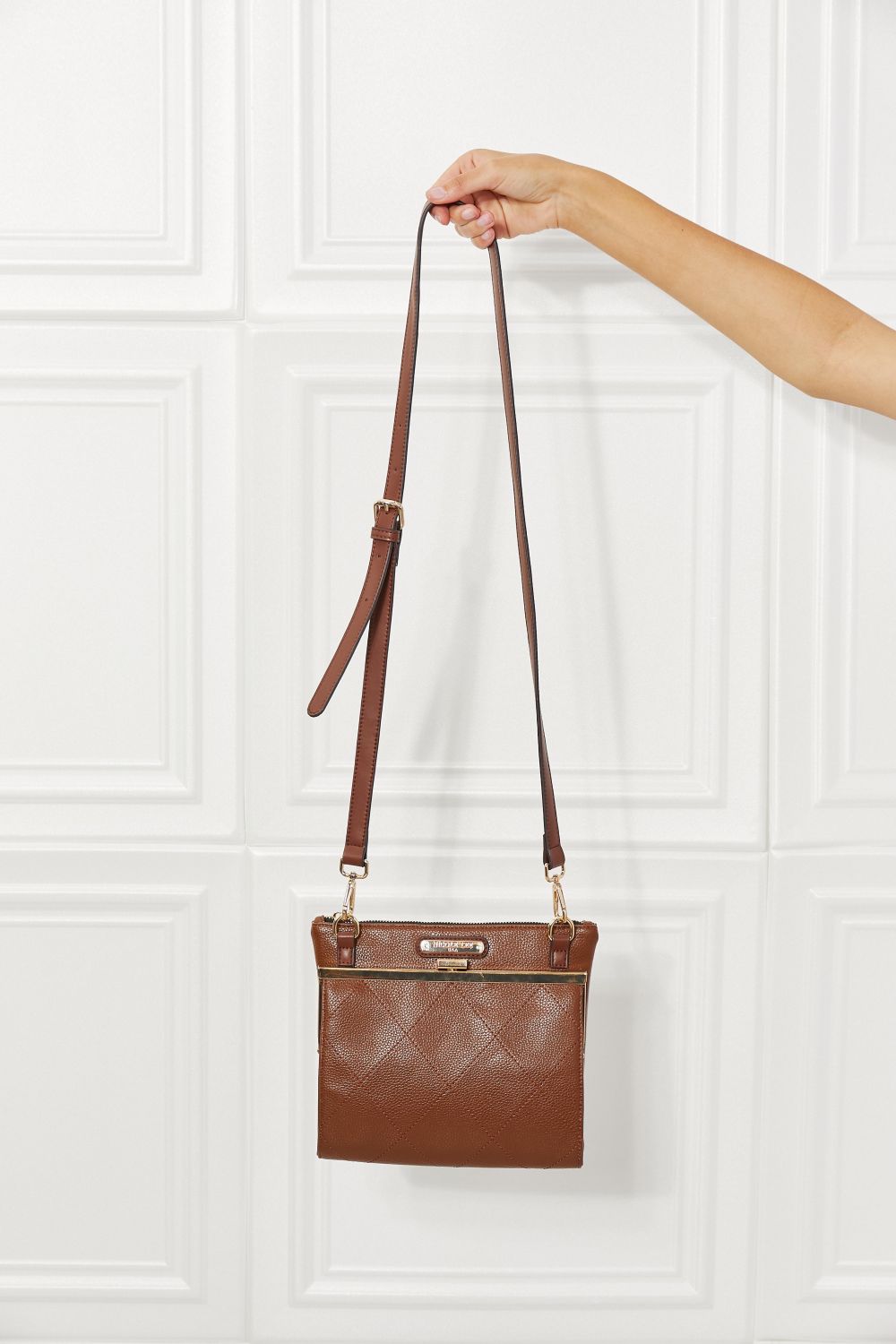 Chestnut brown rectangular handbag with double shoulder straps and gold hardware