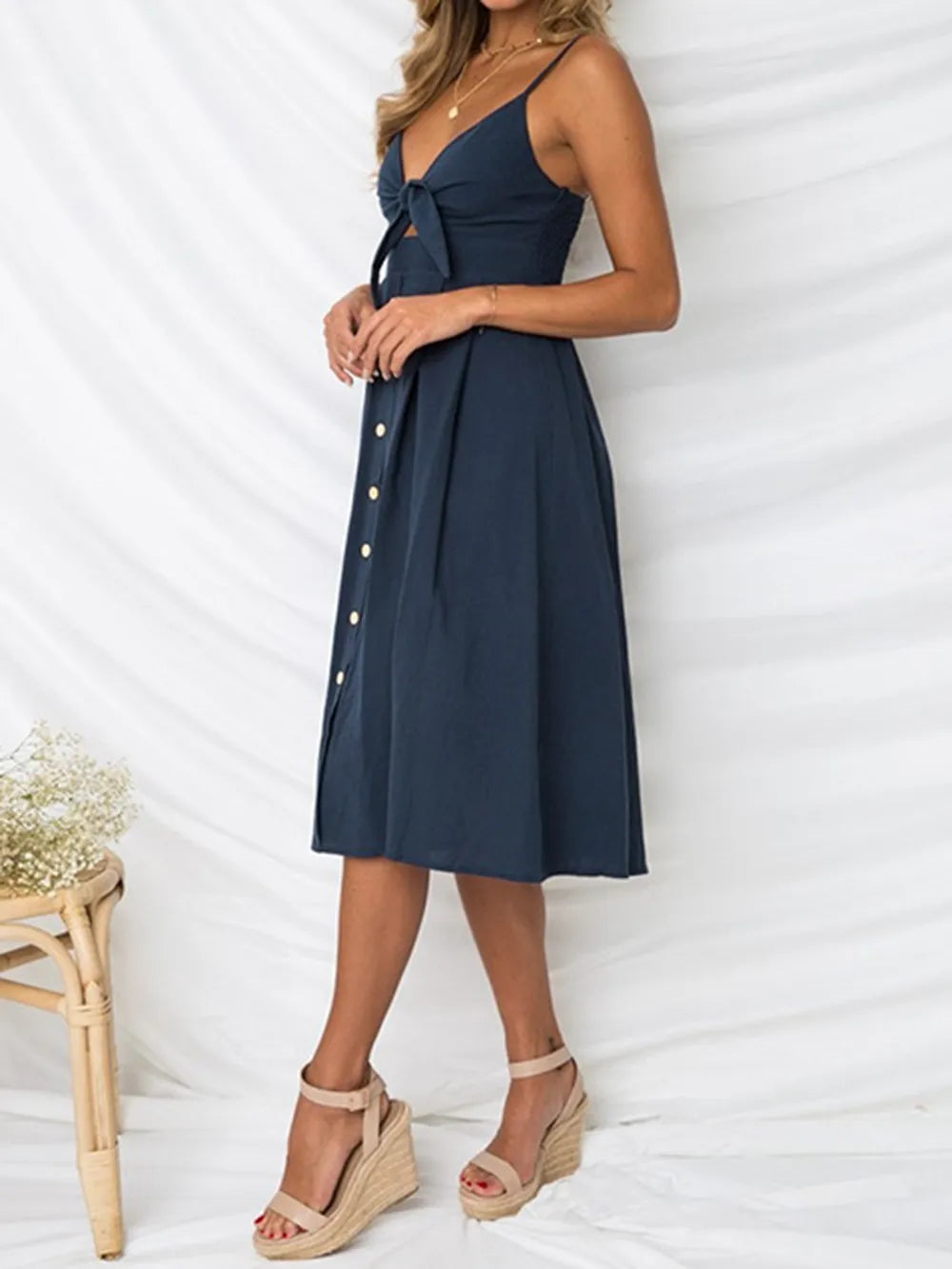 Dark blue cami dress with sweetheart cutout, bow tie bodice, button midi skirt