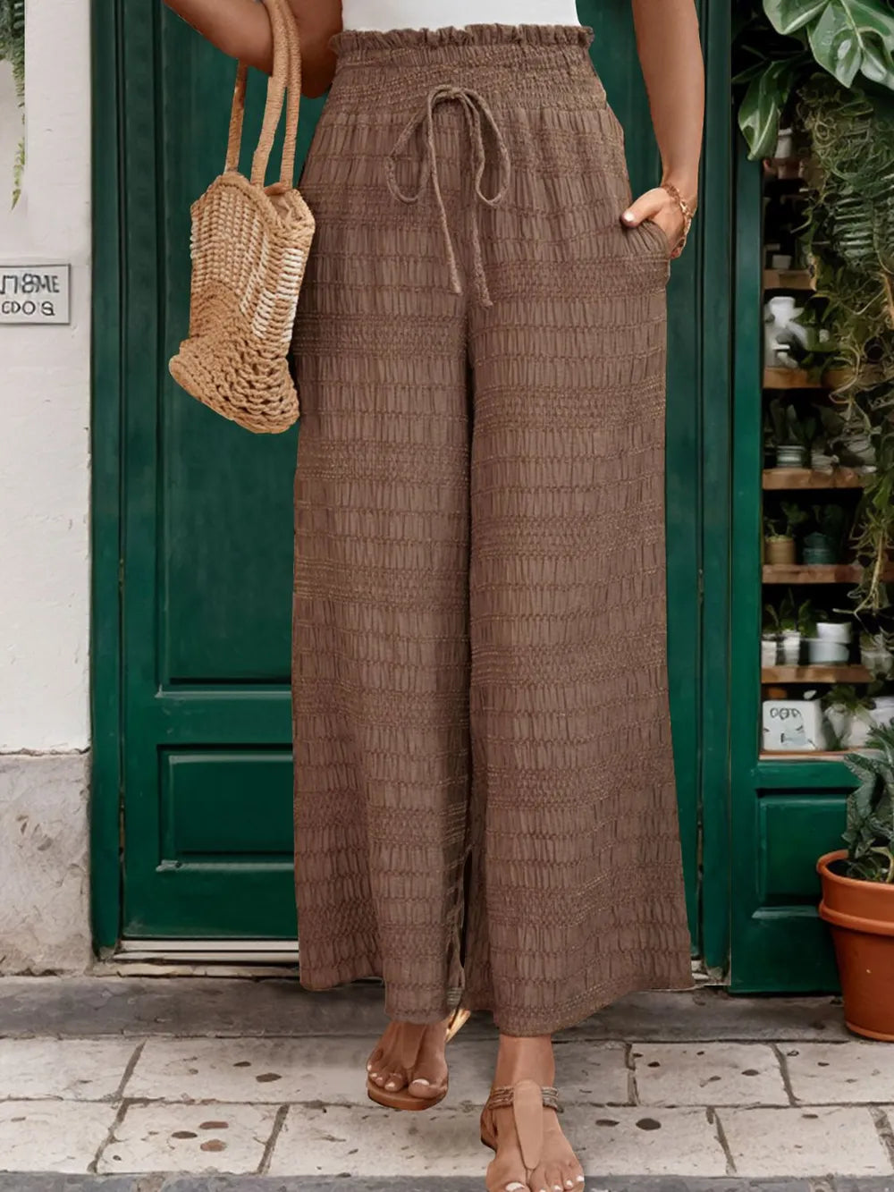 Brown wide-leg pants with elastic drawstring waist, textured full-length legs