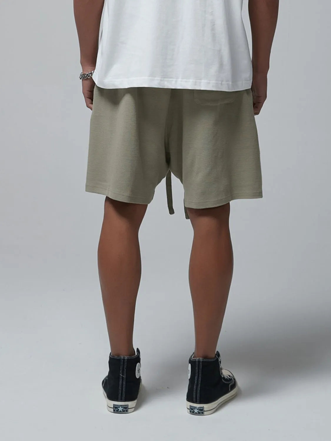 Men's sage waffle shorts with drawstring tie and side pockets, back view