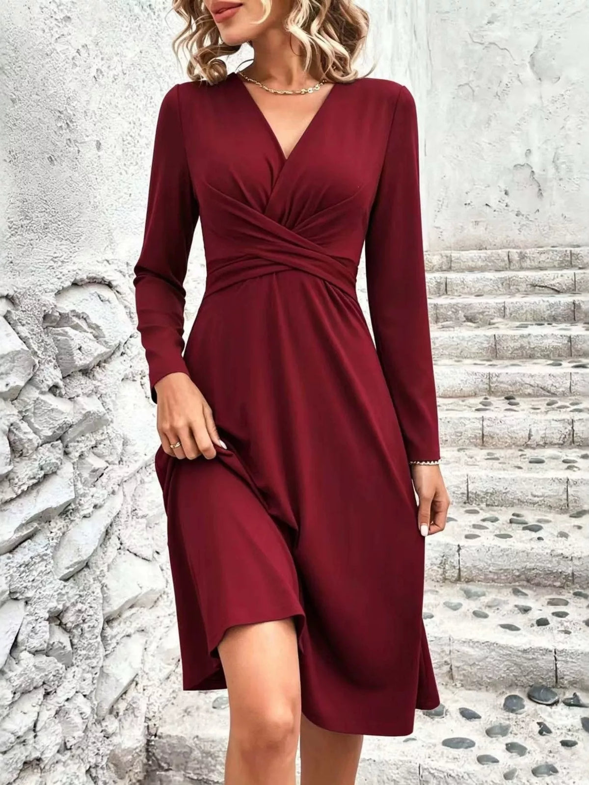 Burgundy long-sleeve surplice midi dress with ruched waist and wrap V-neck