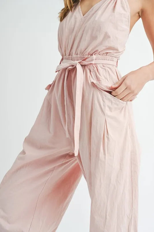 Pink belted jumpsuit with tied waist and gathered hip fabric detail