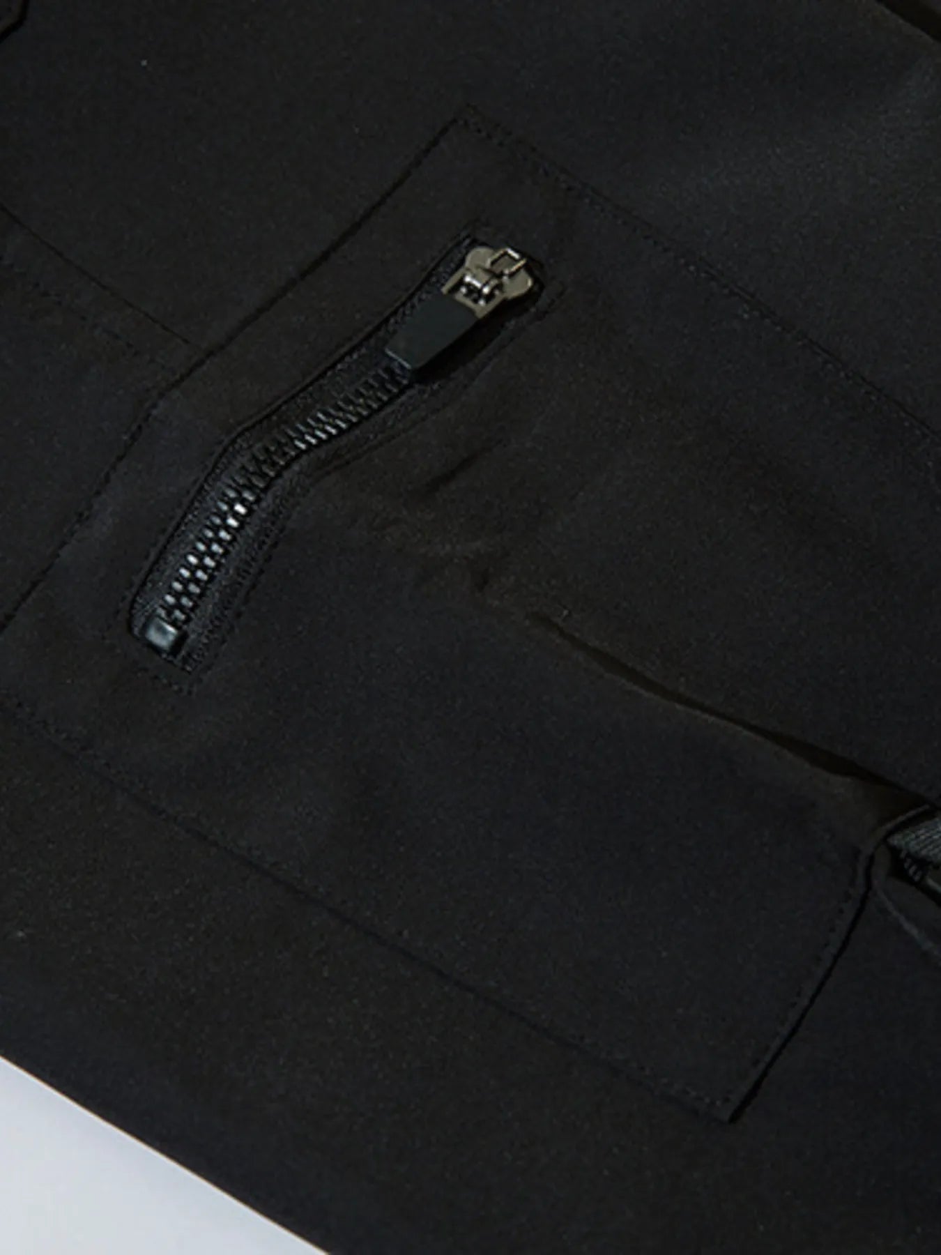 Black cargo joggers featuring a slanted zippered pocket on the leg