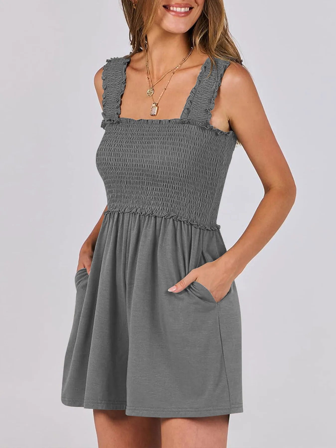 Dark gray smocked square-neck summer romper, sleeveless with ruffled neckline and pockets