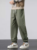 Men's casual army green joggers with pockets, drawstring waist, and cuffed hems