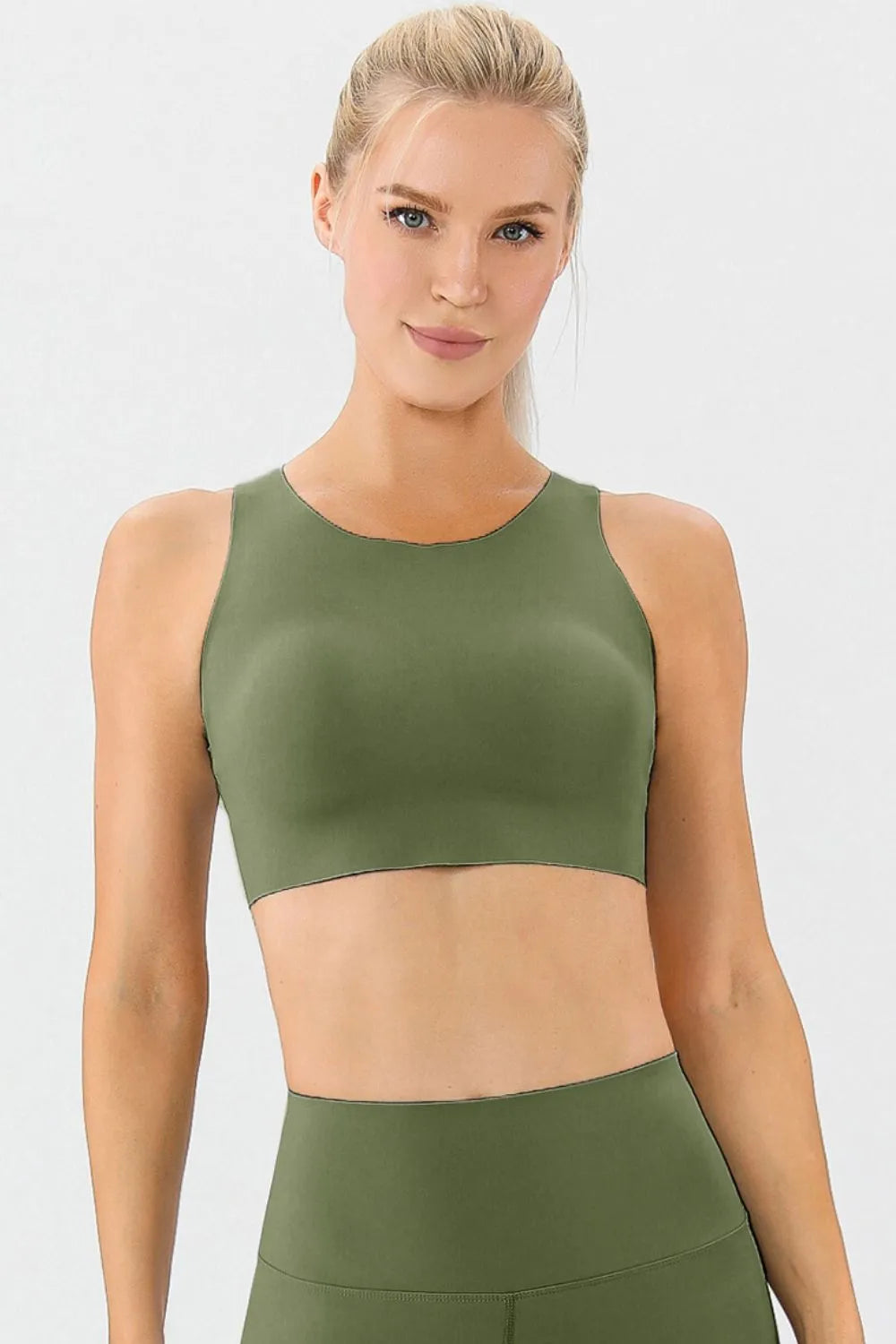 Green active sports bra with round neckline and wide straps, front view