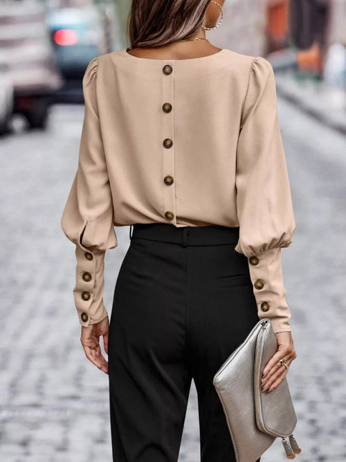 Tan blouse with vertical back buttons and lantern sleeves, gathered cuffs.