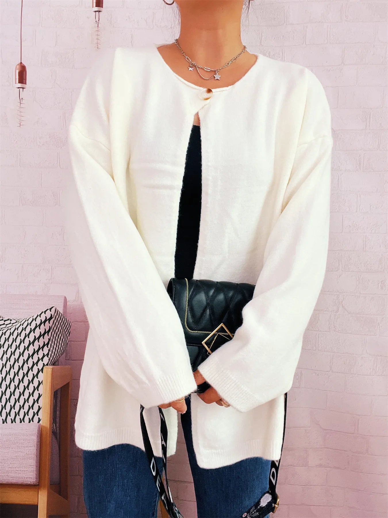 White one-button drop-shoulder cardigan with long sleeves and crew neckline