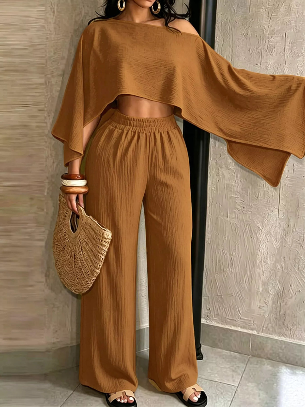 Brown boat-neck crop top with draped sleeves and wide-leg pants set