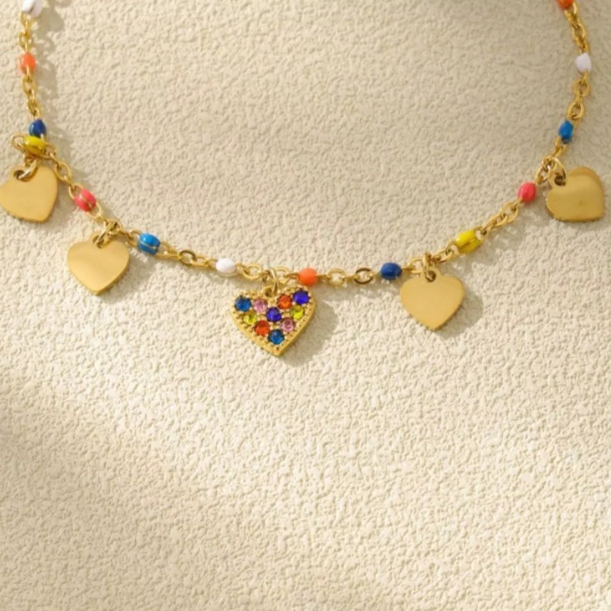 Gold-plated heart charm necklace with multicolor beads and multiple gold heart charms