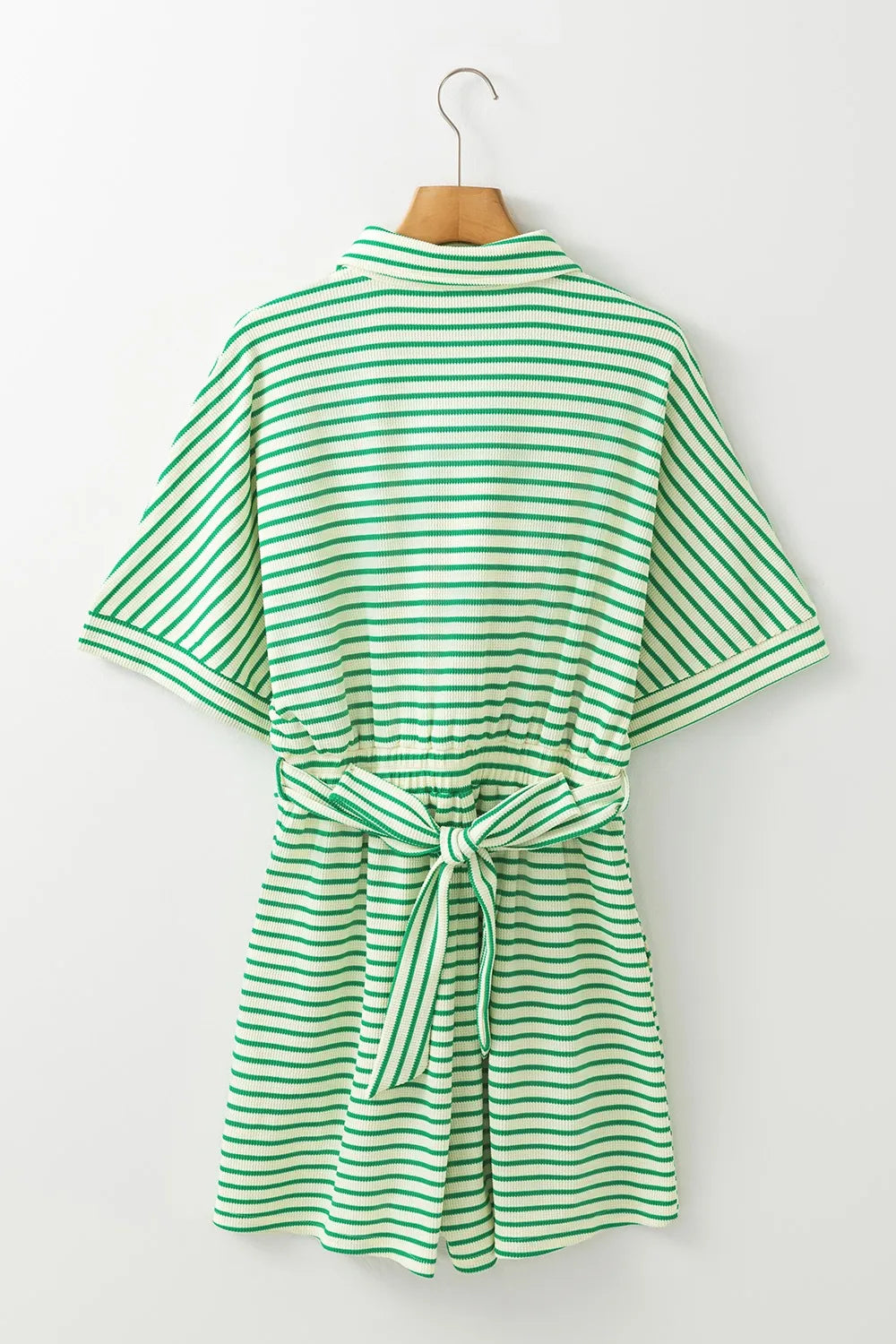 Green and white striped romper on hanger, back view with tie waist belt