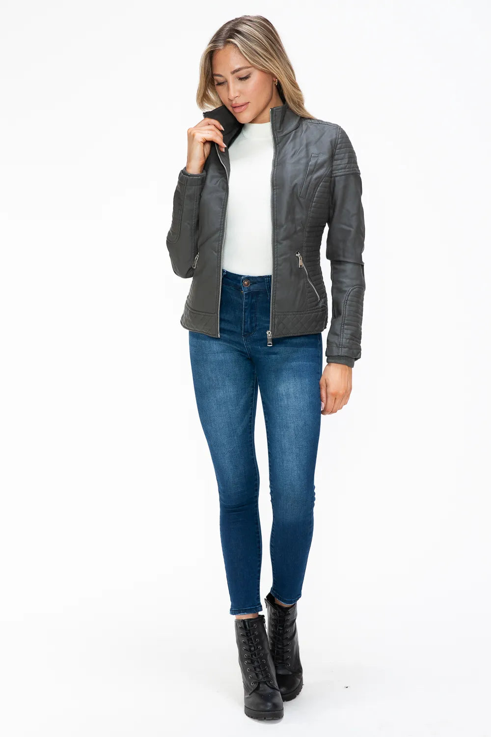 Charcoal double-zipper jacket with hood, worn with hands at pockets