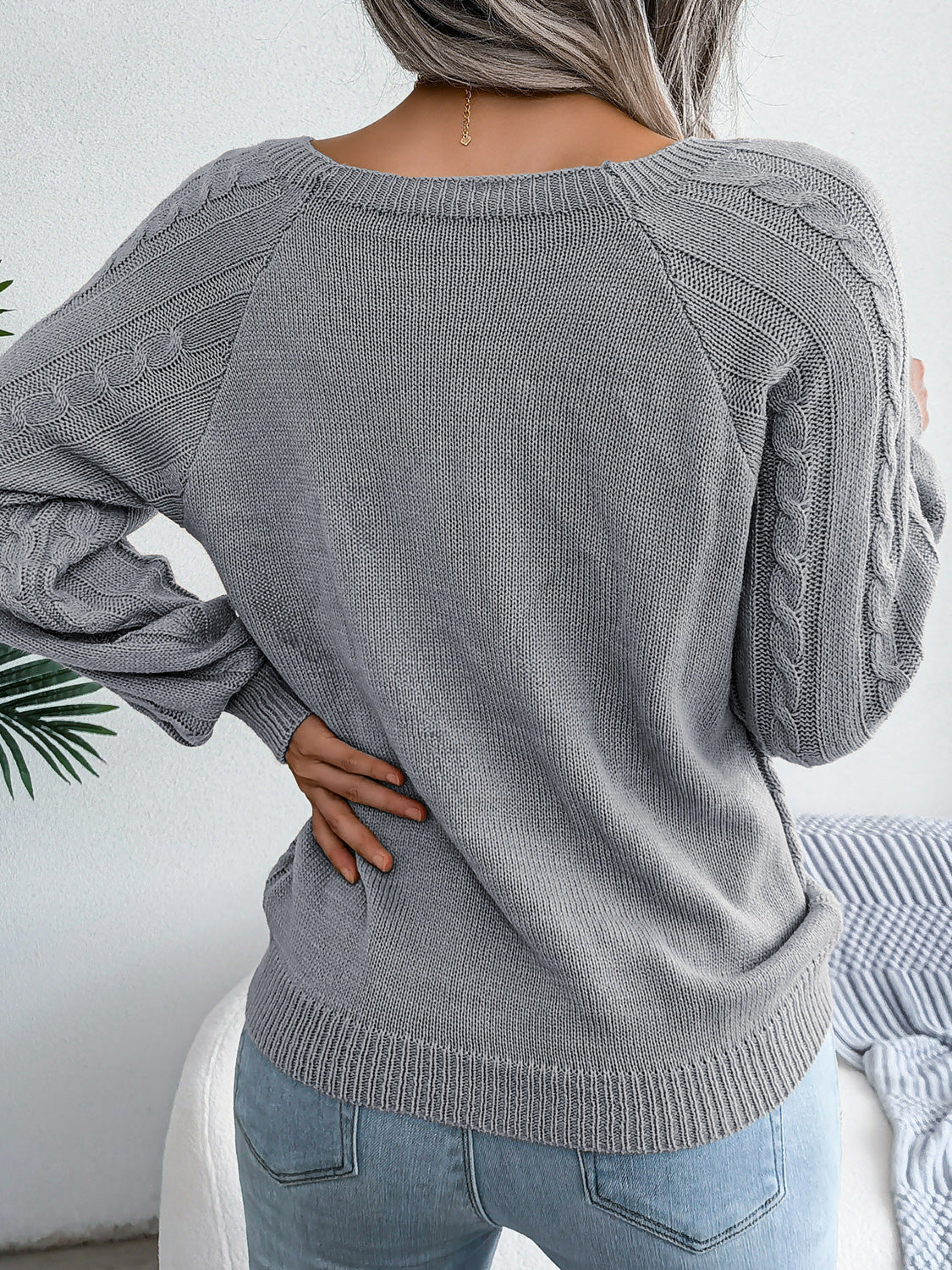 Gray cable-knit sweater with cable-knit back, long sleeves, relaxed fit
