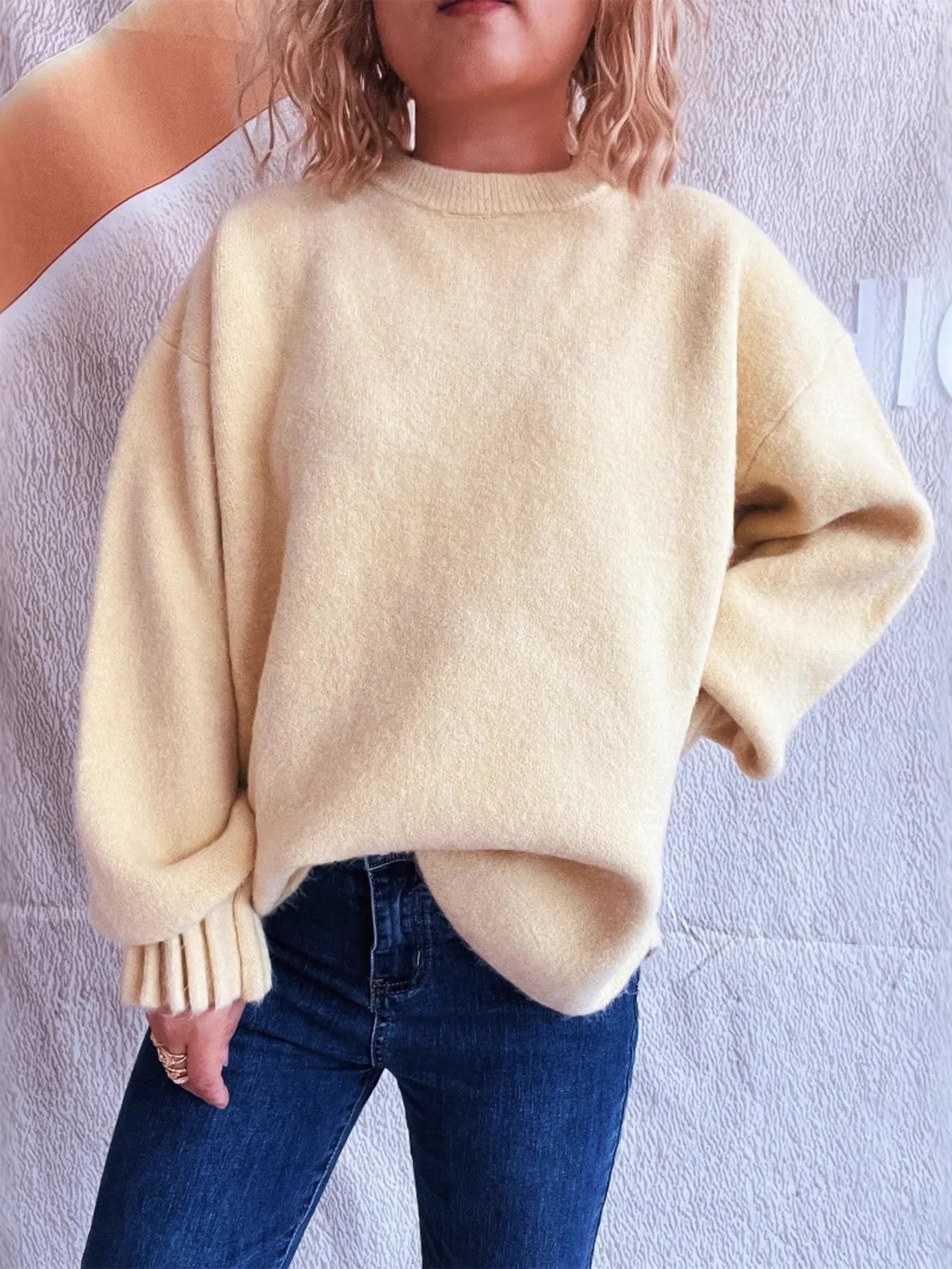Cream round neck dropped-shoulder sweater with ribbed cuffs and relaxed fit