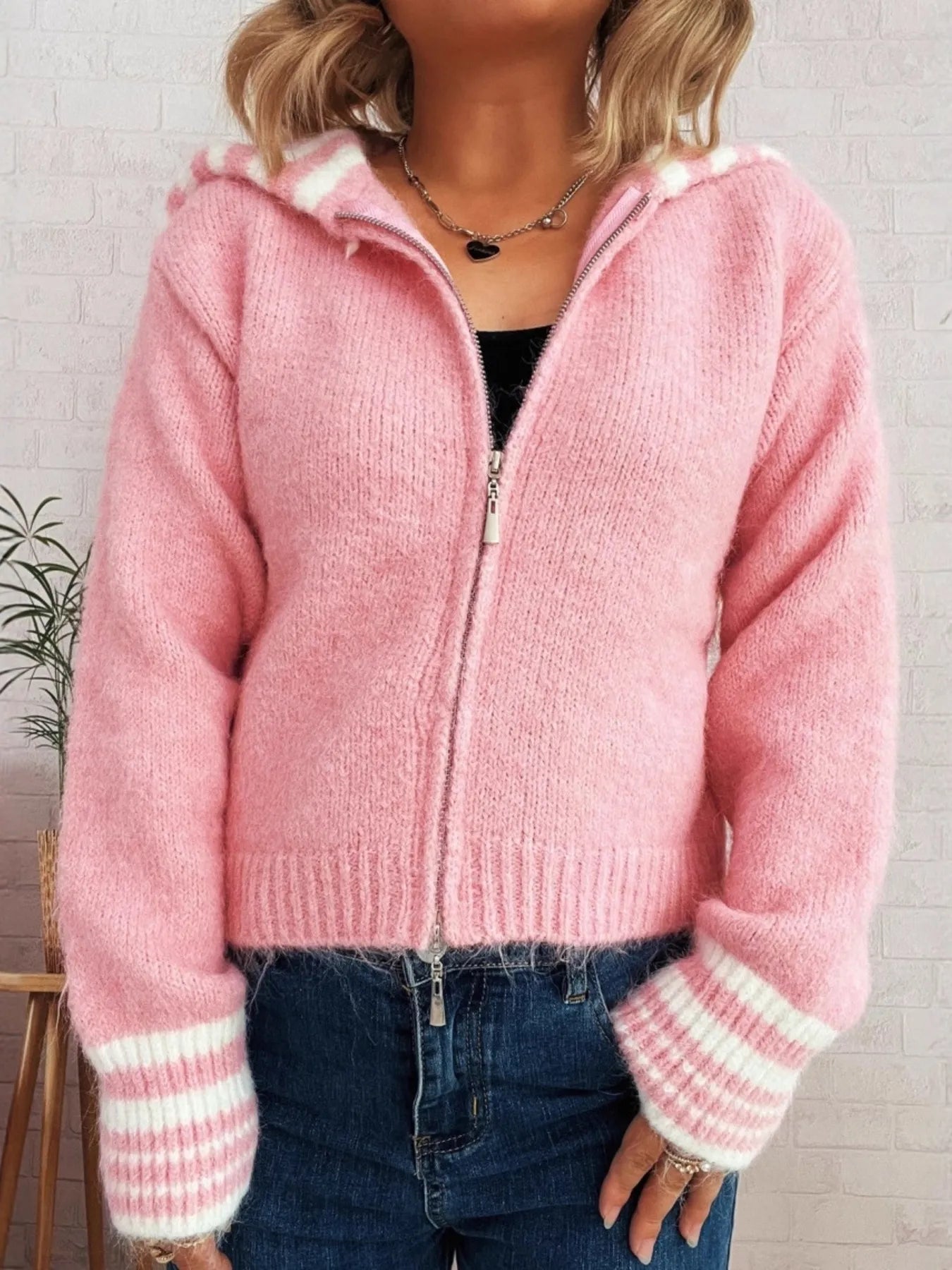 Pink zip-up cardigan with striped cuffs and ribbed hem, front zippered
