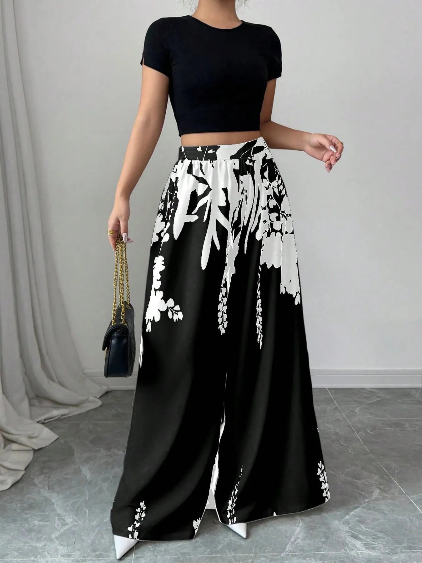 Black and white printed wide-leg pants with elastic waist and drawstring, leaf pattern