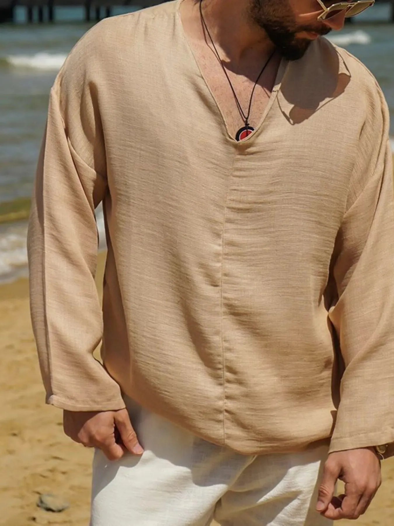Beige V-neck long sleeve men’s top with subtle texture and relaxed neckline