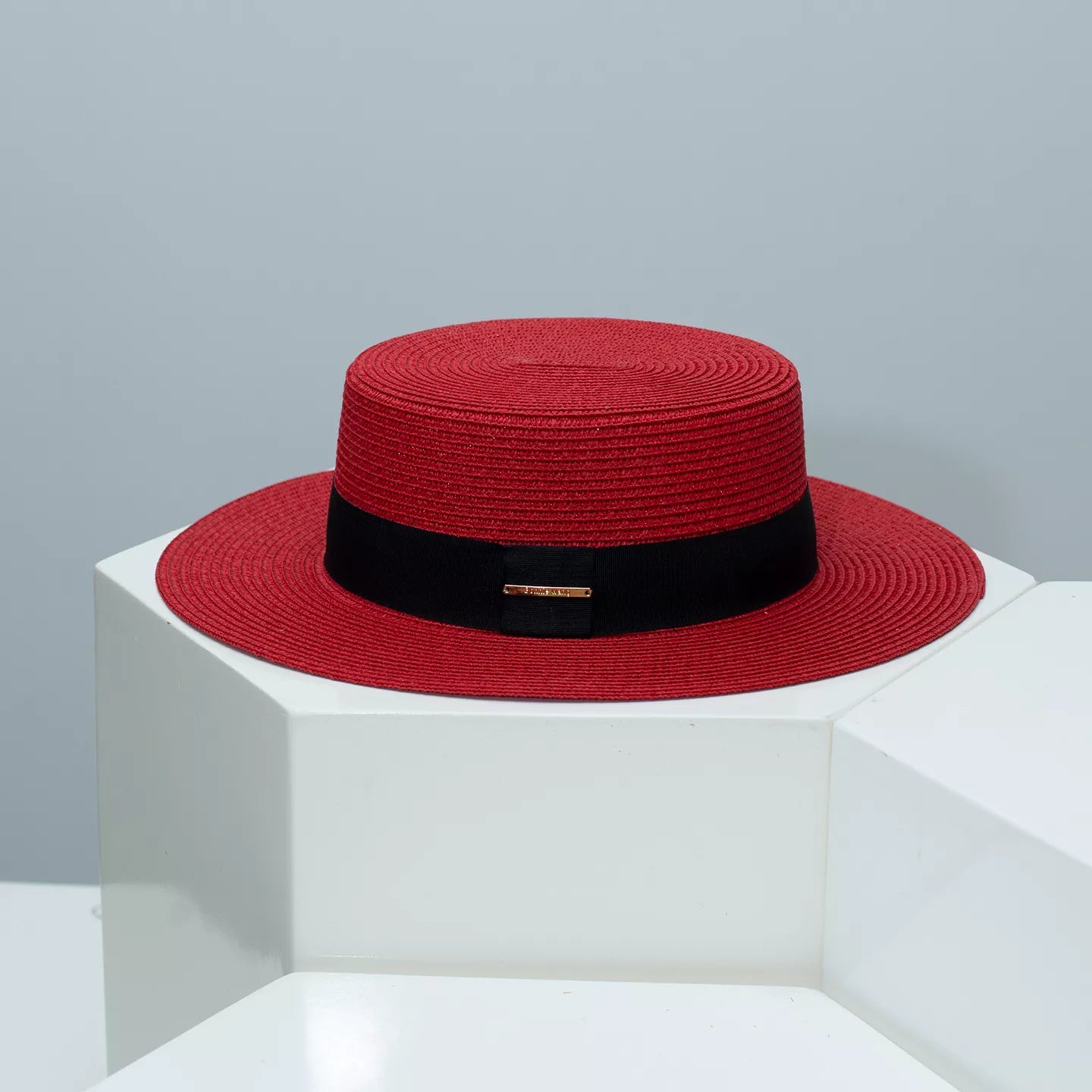 Cedar & Moore red straw boater hat with black band by Trendsi.