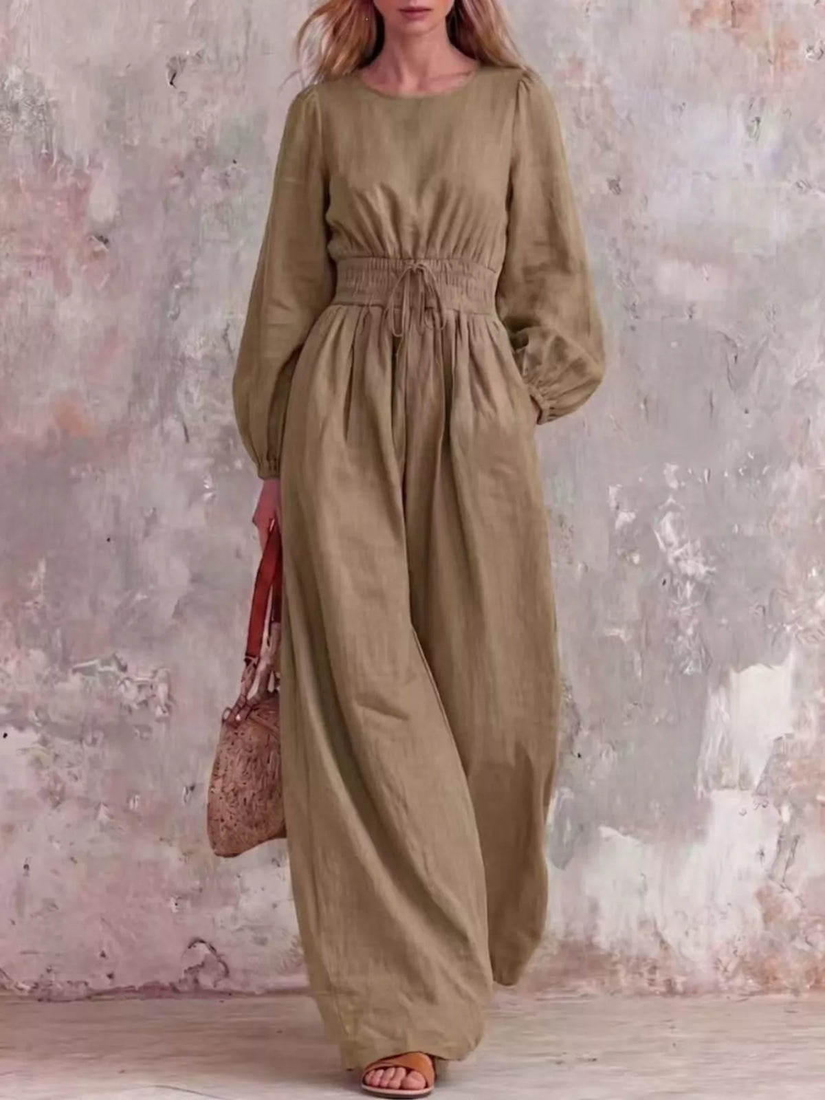 Smocked waist long-sleeve jumpsuit in khaki with gathered waist and wide legs