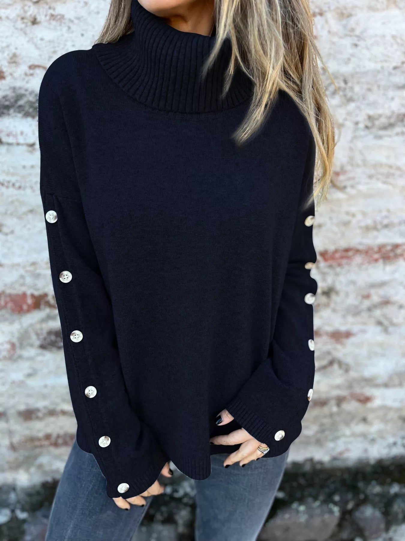 Black turtleneck long sleeve sweater with ribbed collar and buttoned sleeve cuffs