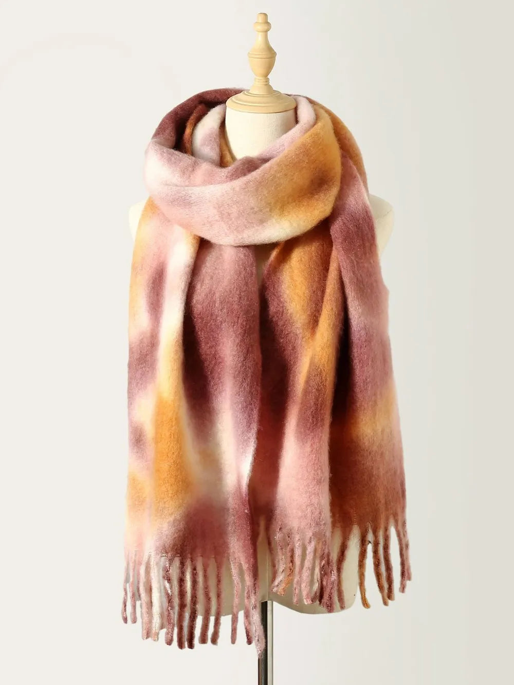Tie-dye polyester scarf with fringe, blush pink and warm brown tones, draped on mannequin