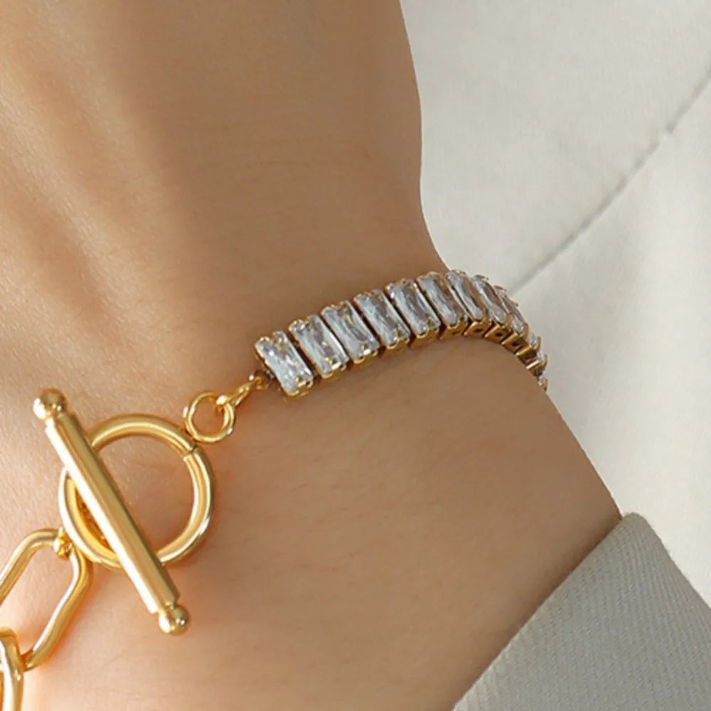 Gold-tone bracelet with rhinestone cuff segment and open-link chain