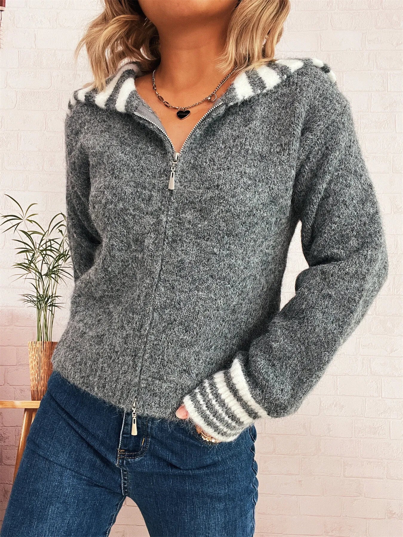 Gray zip-up cardigan with striped hood trim and ribbed striped cuffs