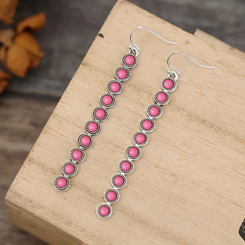 Pink cabochon long dangle earrings with silver-tone hooks, lined round discs