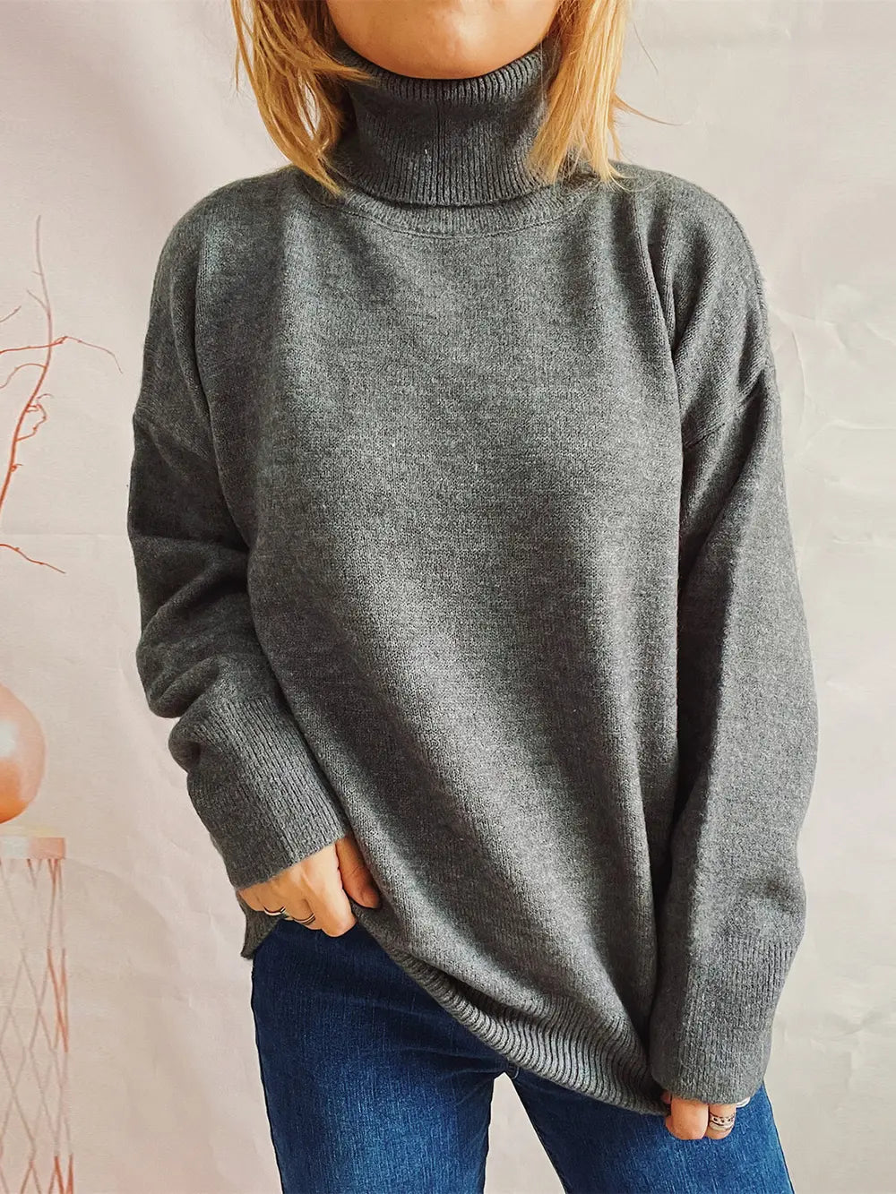 Turtleneck long-sleeve sweater in charcoal gray, ribbed neckline and sleeve cuffs.