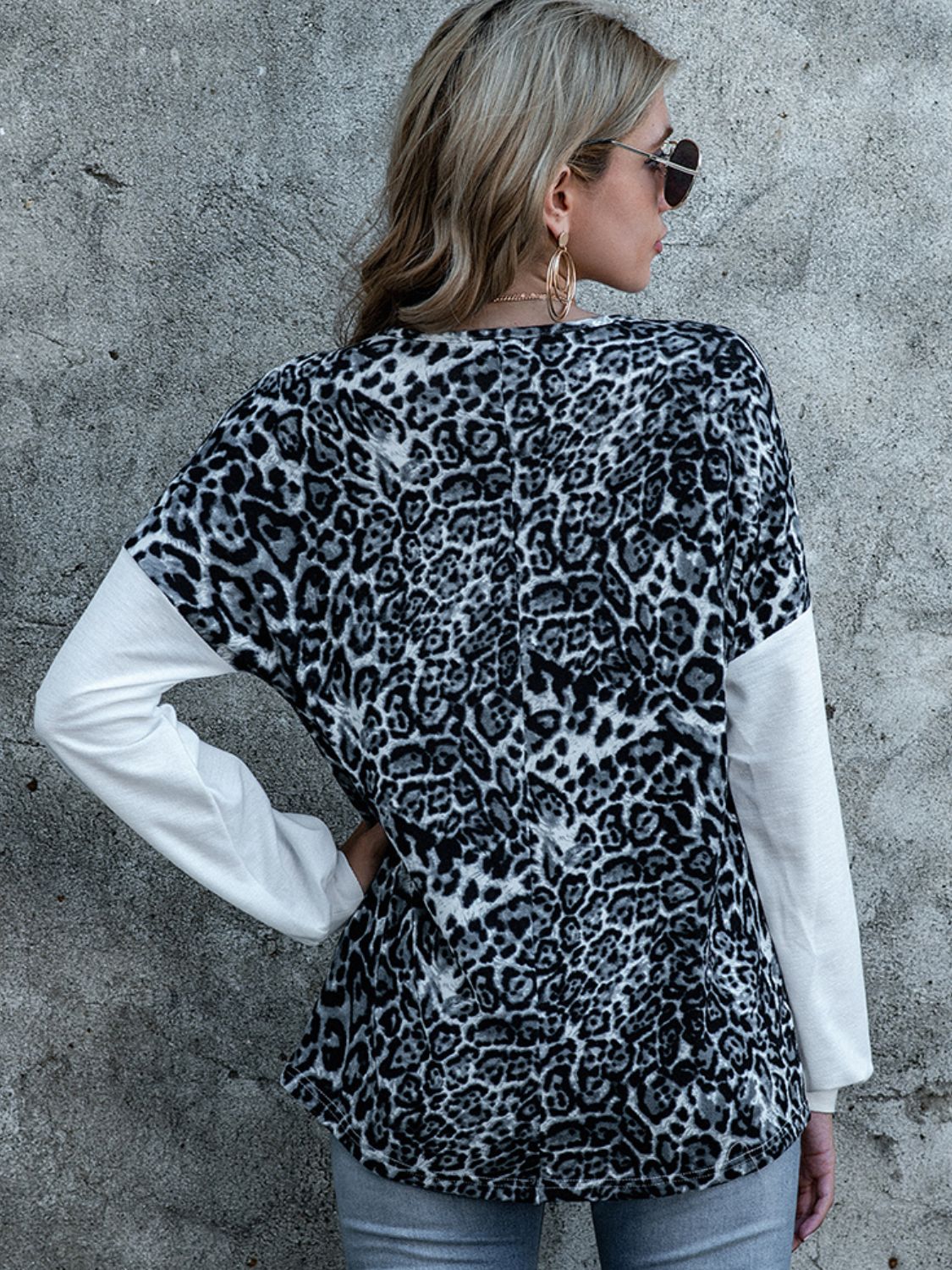 Leopard print V-neck top with white long sleeves, back view