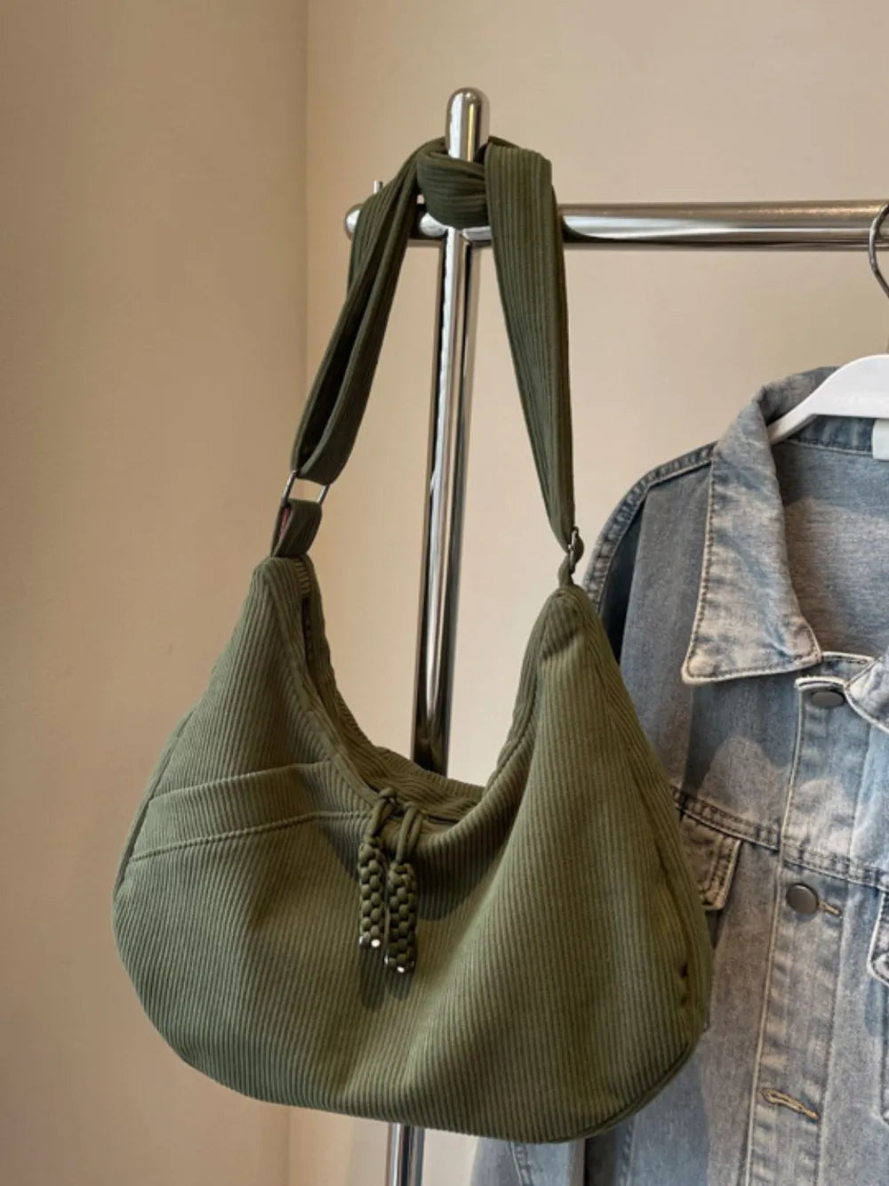 Moss green ribbed shoulder bag with adjustable strap and braided tassel pull top