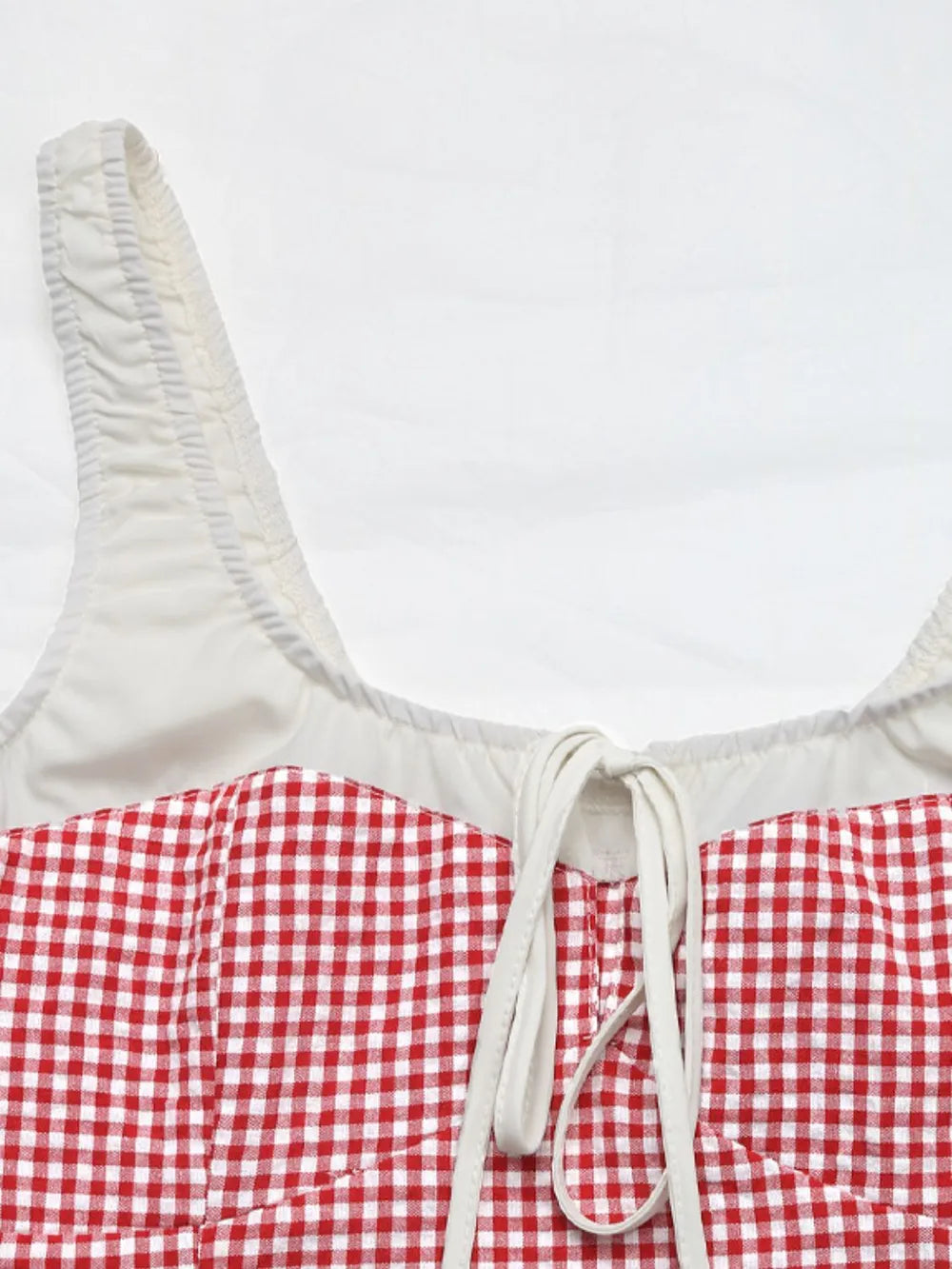 Square-neck tank top with white contrast trim and front drawstring tie in gingham