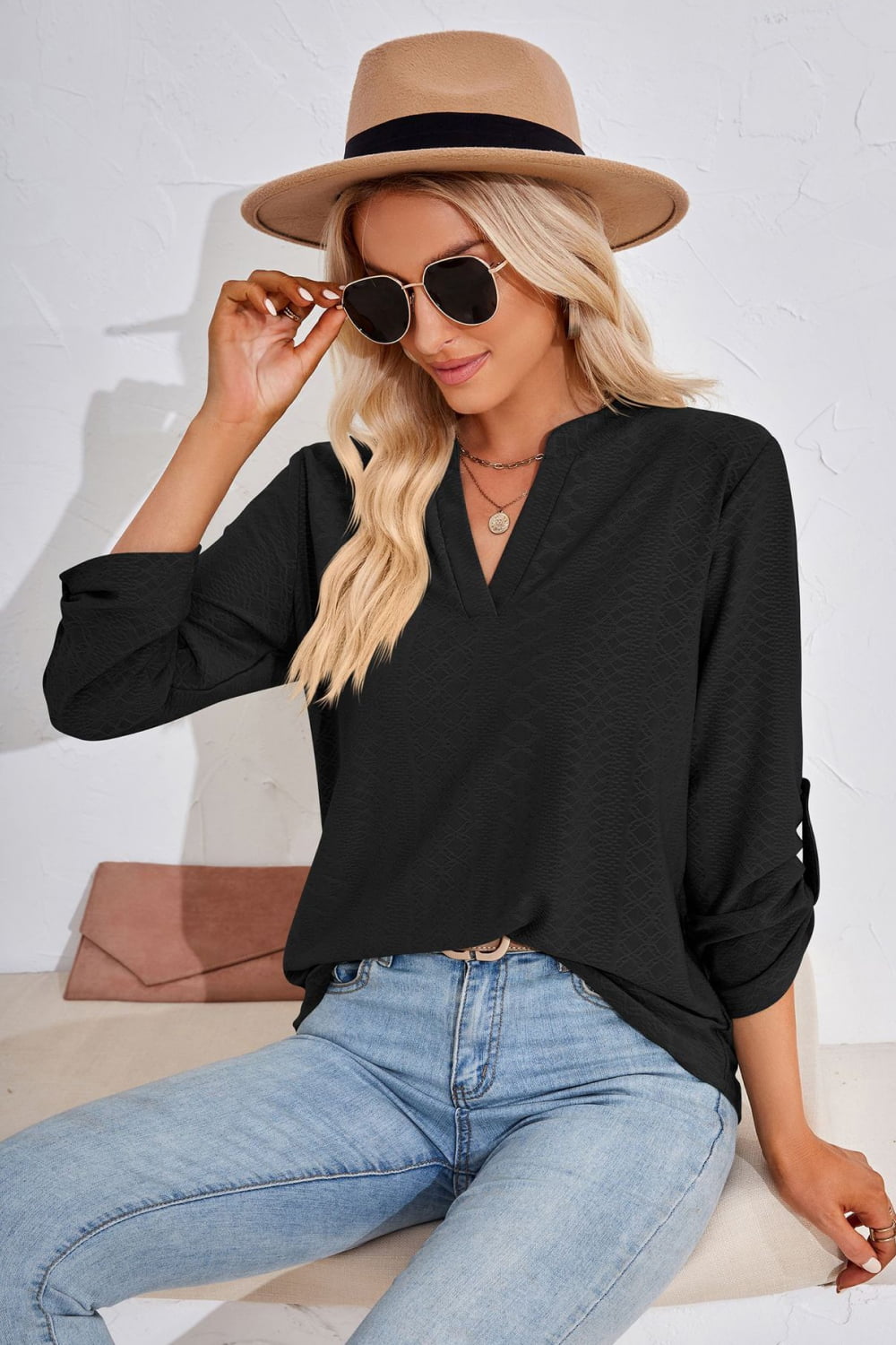 Black V-neck blouse with V-neckline and roll-tap sleeves