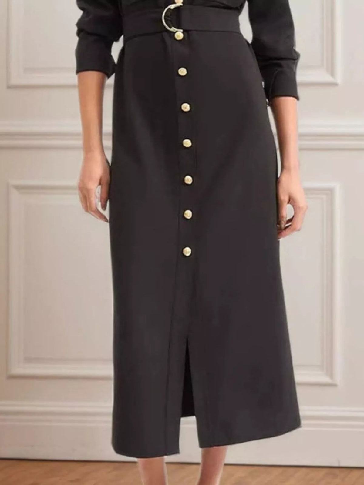 Black belted long-sleeve midi dress with gold button front and center slit