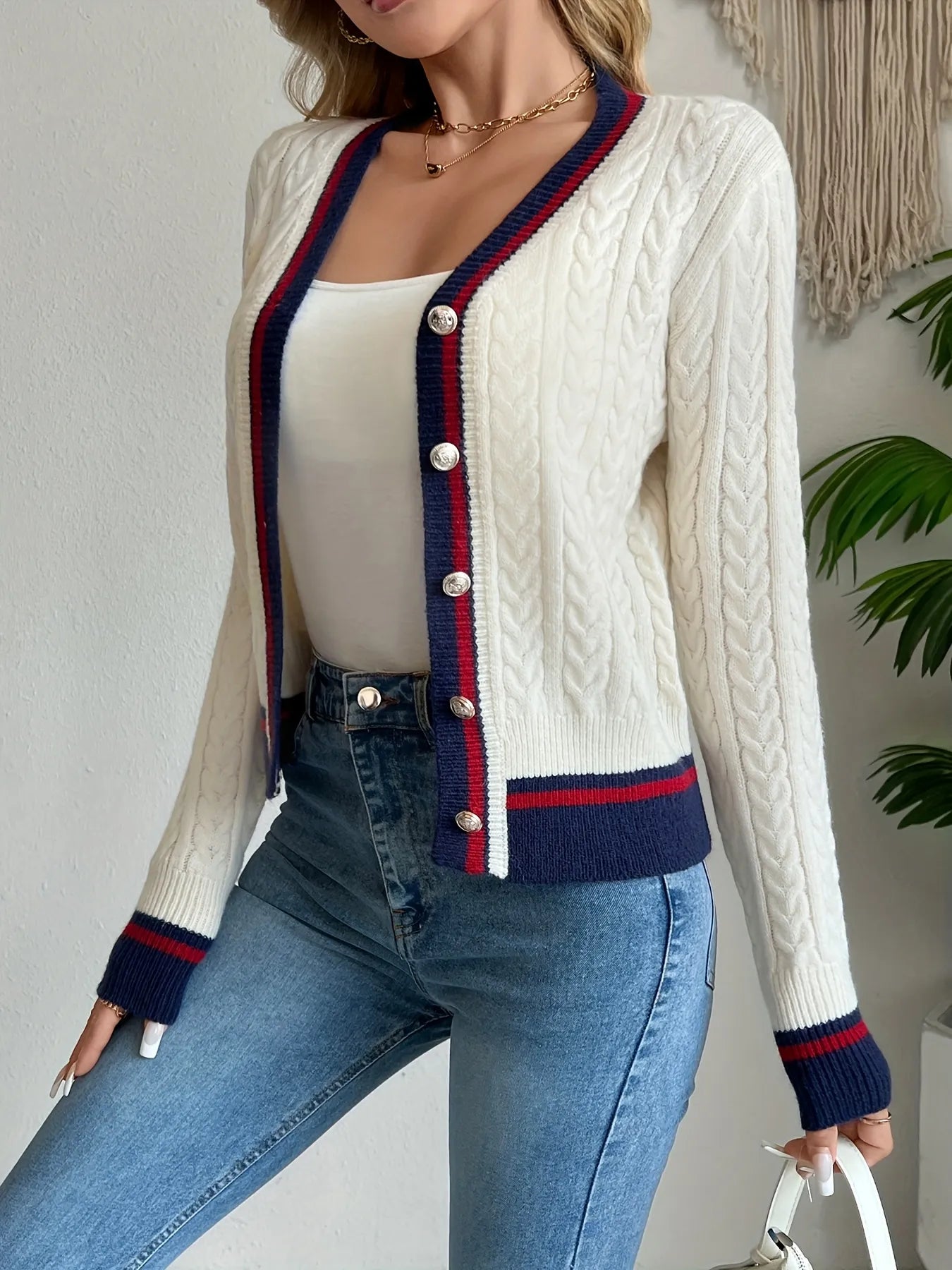 Ivory cable-knit V-neck button-front cardigan with navy and red striped trim