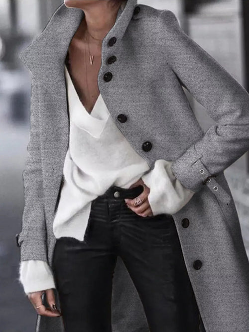 Dark gray longline button-down coat with belt and dark buttons, worn open at front
