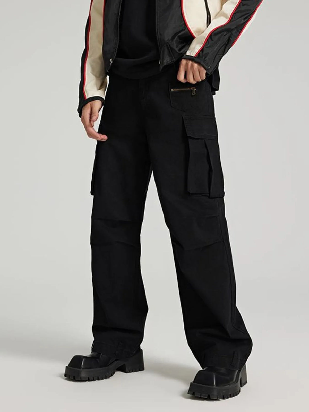 Black cargo jeans with large flap cargo pockets and relaxed straight-leg fit.